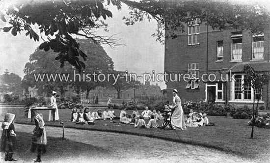 Tea on the Lawn of Queen Victoria House, Dr Barnado's Village Home for girls, Near Ilford, Essex. 1907